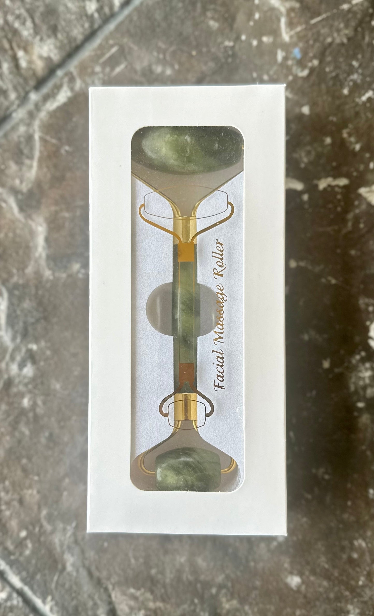 Jade Roller used on cheek — lymphatic drainage and de-puffing massage motion